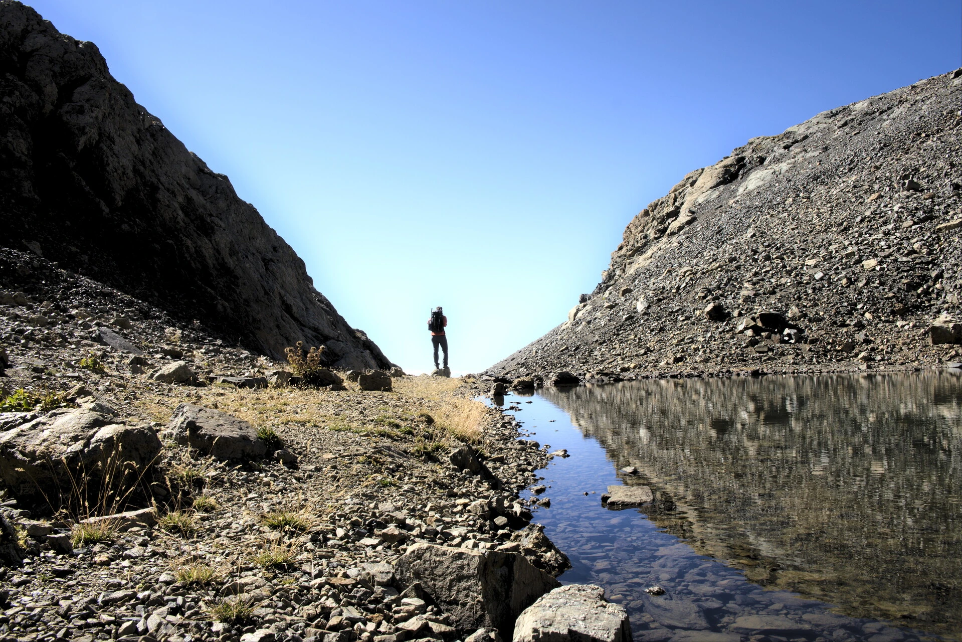 Small mountain lake below the ridges of Vieux Chaillol