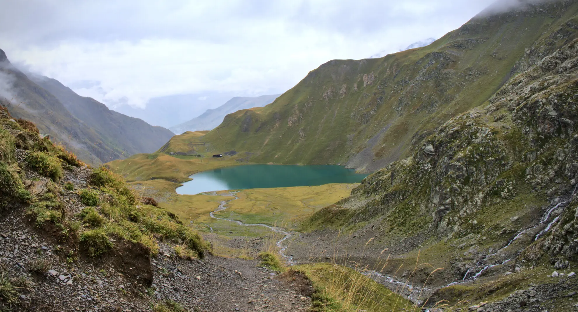 Lac de la Muzelle from the descent trail, with the refuge at the water's edge